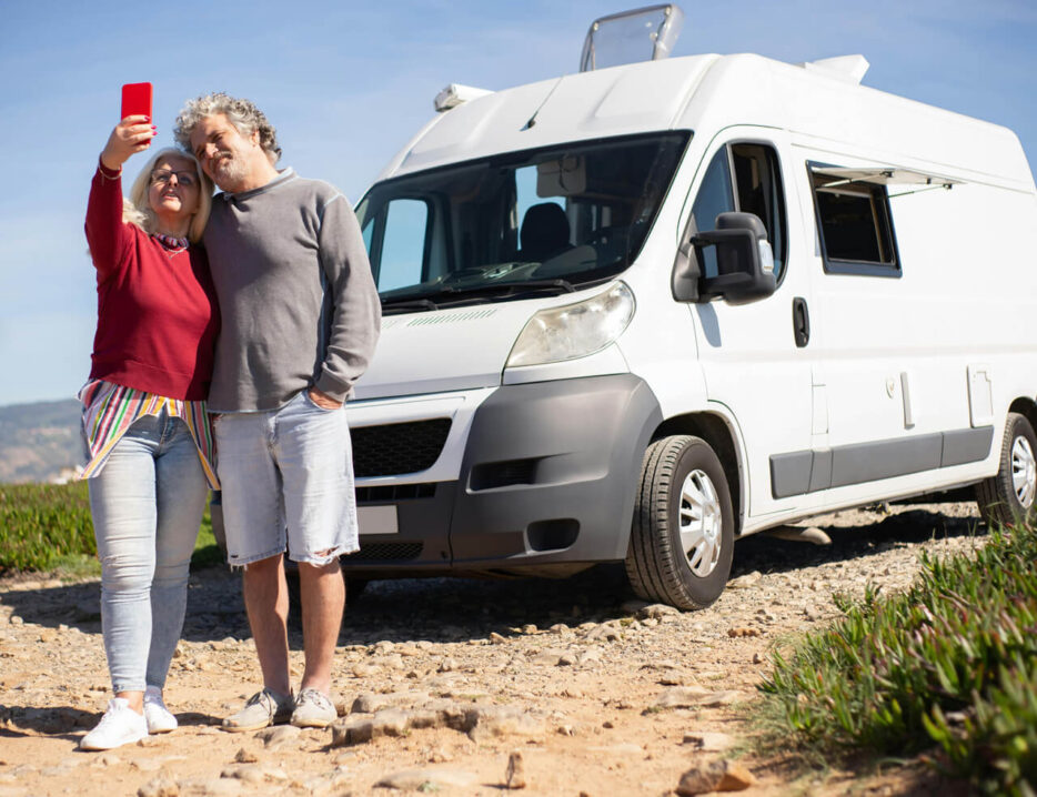 couple takes selfie in front of their new RV van