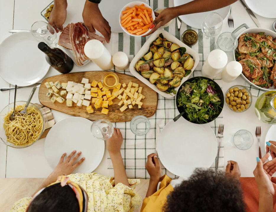 various food items on a table as seen from above at a family meal