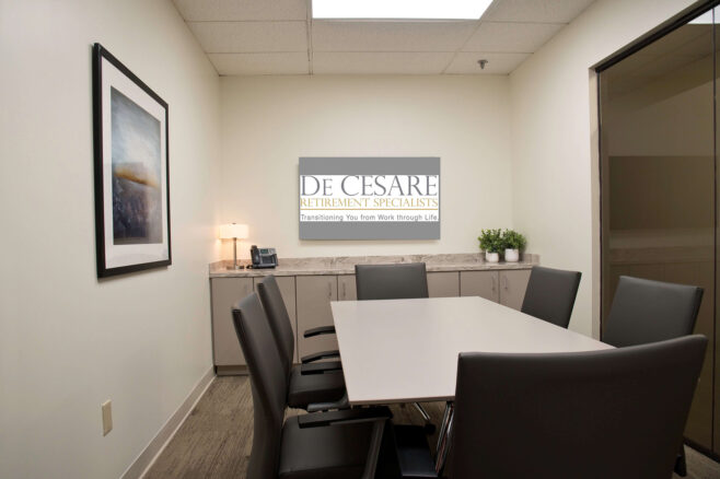 photo of empty conference room with a screen that shows De Cesare logo
