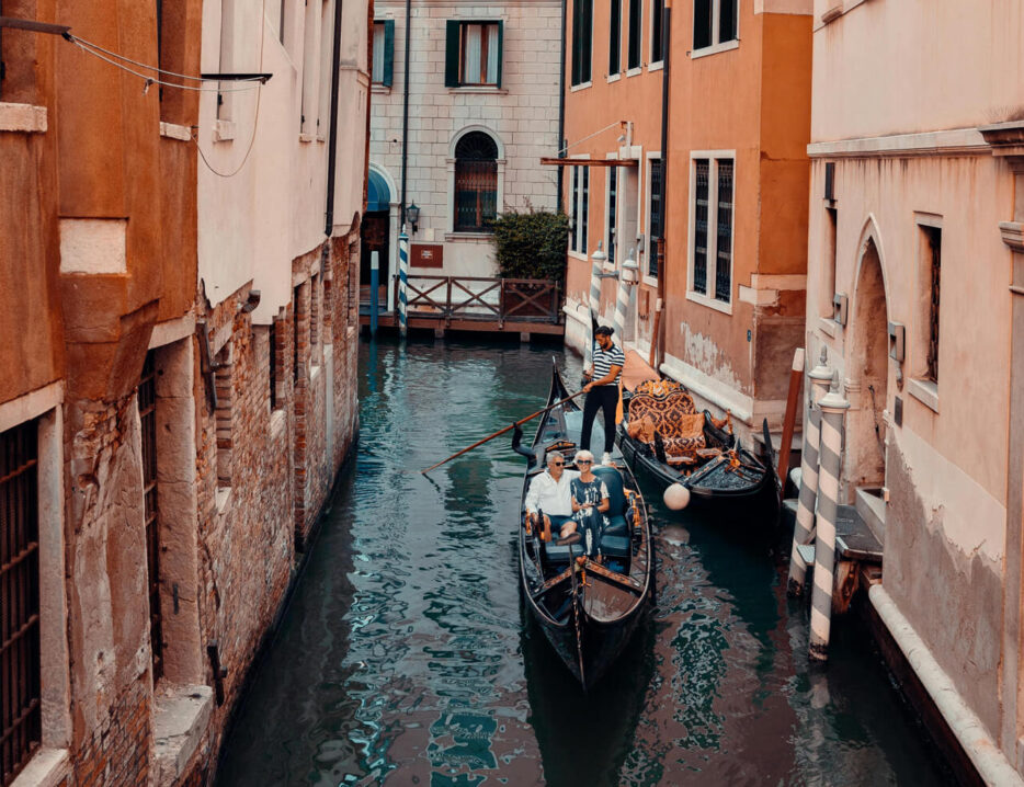 A retired couple sits in a Venice canal boat