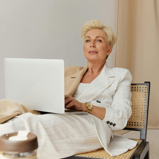 confident woman CEO relaxes with her laptop